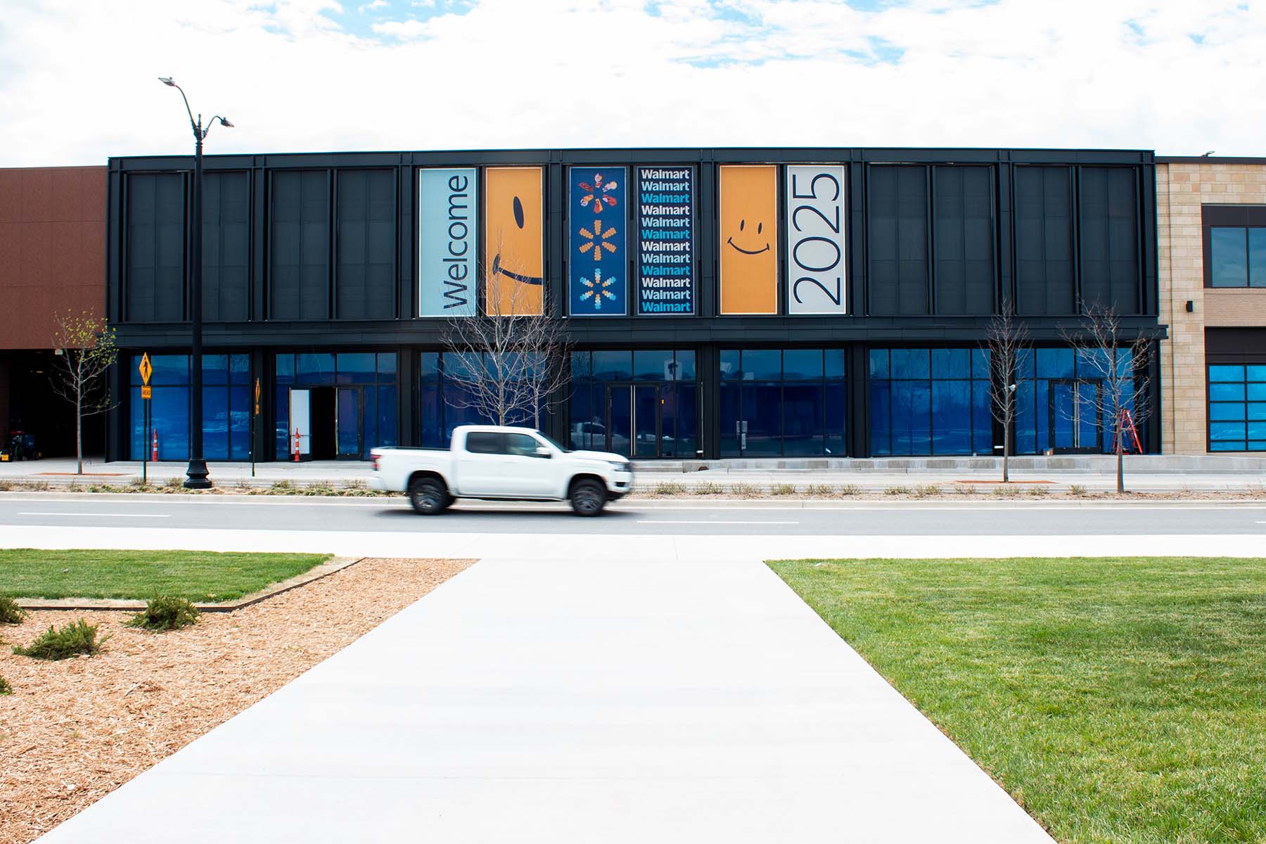 Walmart storefront with “Welcome” and “2025” banners above the entrance